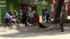 A policeman uses a dog to disperse rioters during the second day of skirmishes in the Eastleigh neighbourhood of Kenya's capital Nairobi, November 19, 2012. 