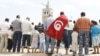 People attend Friday prayers during a demonstration in support of the ruling party Ennahda, in Tunis August 31, 2012. 