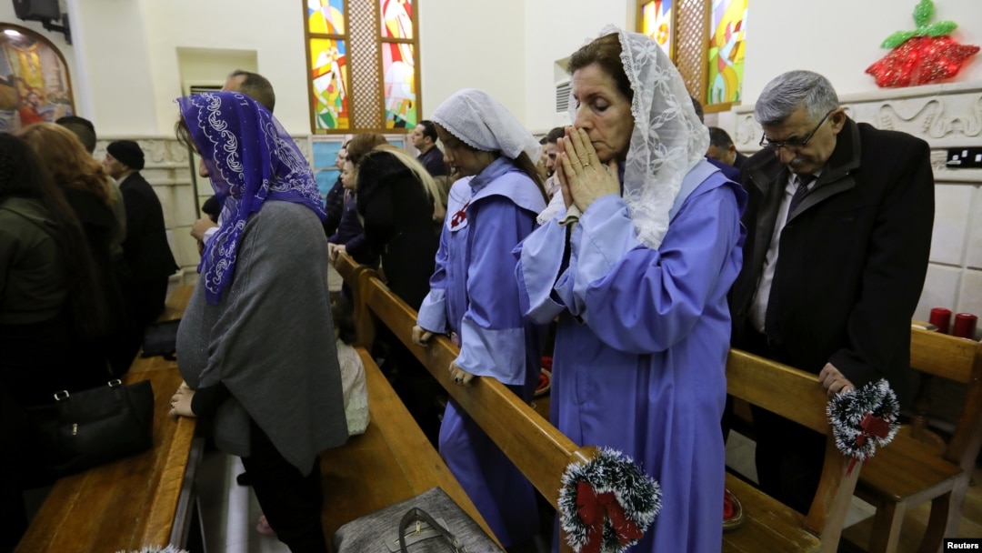 Iraqi Christians pray during a mass on Christmas at St George Chaldean Catholic Church in Baghdad, Iraq, Dec. 25, 2018. 
