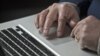 A U.S. cyber warfare expert works on his laptop computer, December 1, 2011.