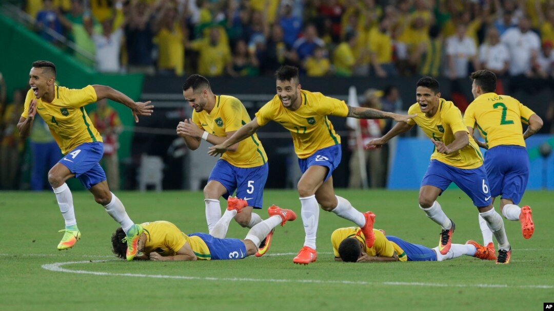 Brazil's players react as Neymar scores the decisive penalty kick during the final match of the men's Olympic soccer tournament at Maracana Stadium in Rio de Janeiro, Brazil, Aug. 20, 2016.