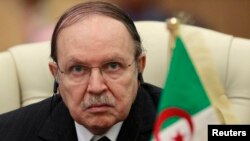 Algeria's President Abdelaziz Bouteflika listens to the speech of Libya's leader Moammar Gadhafi at the third European Union-Africa summit in Tripoli, November 2010.