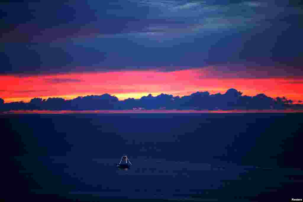A boat sails during the sunset in the sea of Fortaleza, Brazil.