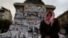 A man looks at the pictures of missing people, believed to be prisoners from Sednaya prison, which was known as a "slaughterhouse" under Syria's Bashar al-Assad's rule, after his ousting, in Marjeh Square in Damascus, Dec. 22, 2024.