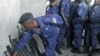 A Congo government policeman hands in his weapon to M23 rebels during an M23 rally in Goma, DRC, November 21, 2012. 