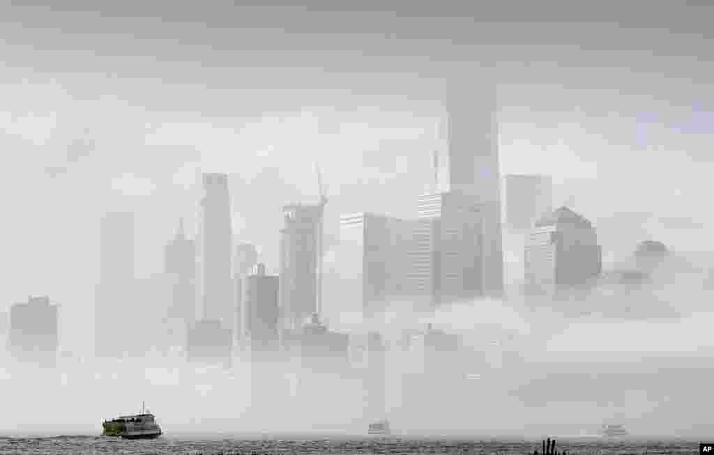A commuter ferry crosses the Hudson River to New York City, in this photo taken from Hoboken, New Jersey.