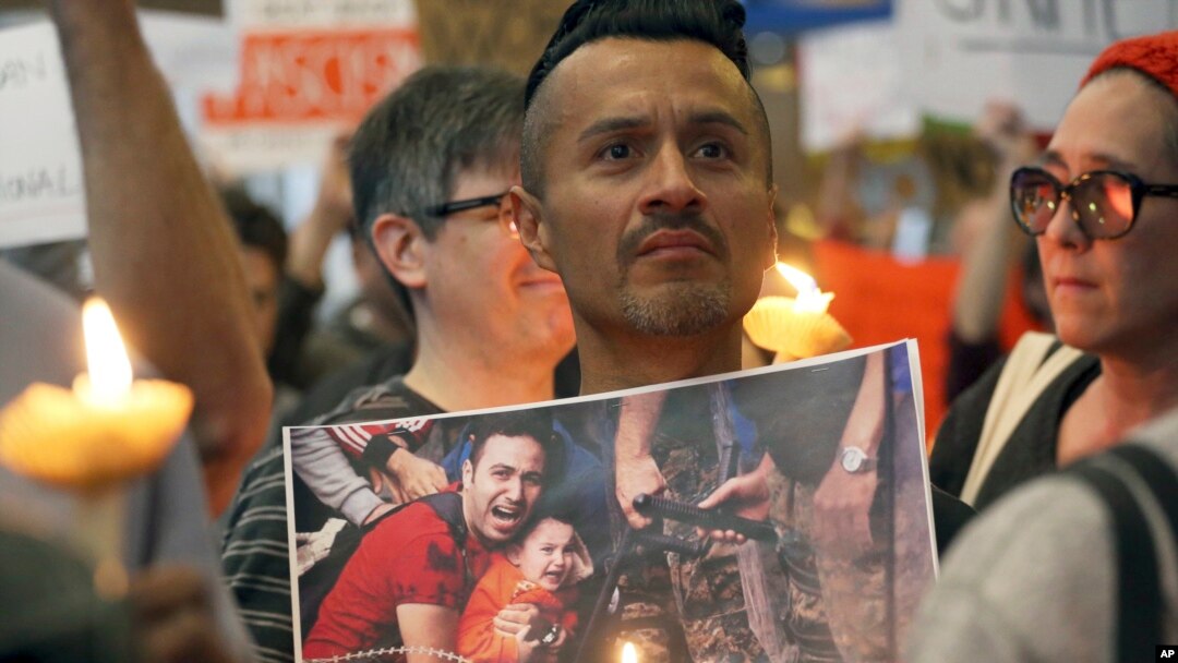 A man joins hundreds of demonstrators opposed to President Donald Trump's executive order barring U.S. entry to Muslims from certain countries, at Los Angeles International Airport, California, Jan. 28, 2017.