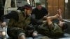 Syrian rebel fighters evacuate a wounded comrade during fighting with government troops in the old city of Aleppo, September 28, 2012. 