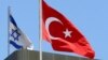 A Turkish flag flutters atop the Turkish embassy as an Israeli flag is seen nearby, in Tel Aviv, Israel, June 26, 2016.