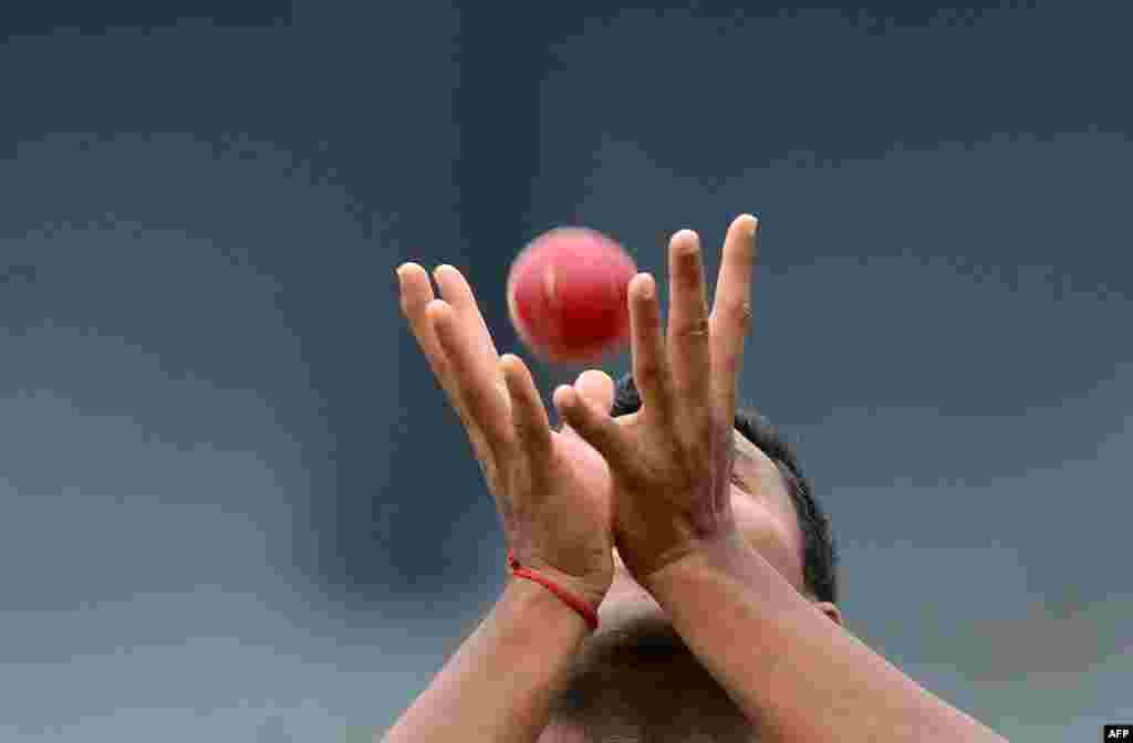 Bangladesh cricketer Subashis Roy catches a ball during a practice session at the R. Premadasa Stadium in Colombo ahead of a Test series in Sri Lanka.