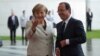German Chancellor Angela Merkel welcomes French President Francois Hollande at the chancellery in Berlin, Germany, May 15, 2012. 