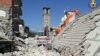 Rescuers work at a collapsed house following an earthquake in Amatrice, central Italy, Aug. 26, 2016.