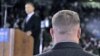 A Secret Service agent stands near then-presidential candidate Barack Obama [background] at a rally in Norfolk, Virginia, October 2008 (file photo) 