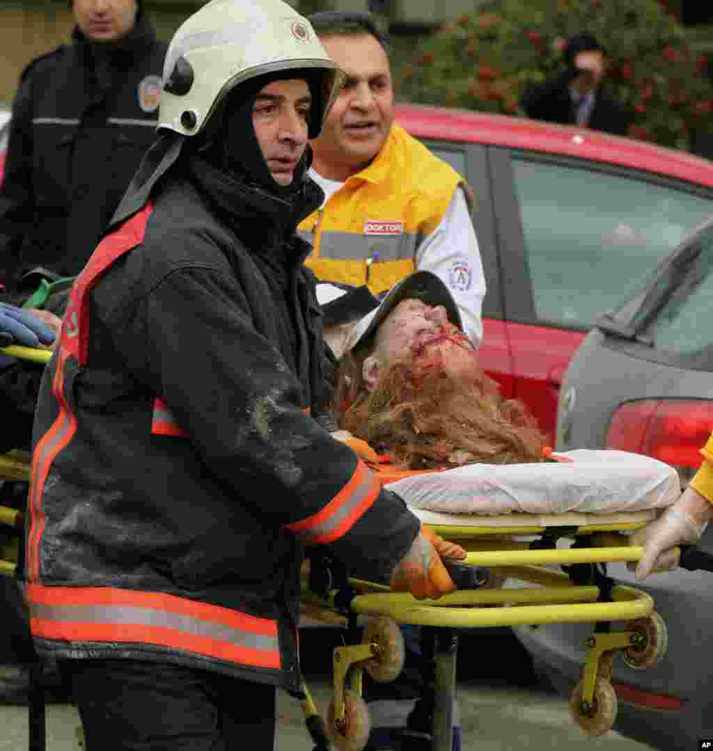 Medics carry an injured woman on a stretcher to an ambulance after a suicide bomber detonated an explosive device at the entrance of the U.S. Embassy in the Turkish capital, Ankara, Turkey, February 1, 2013.