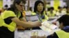Electoral officers count ballots at the central ballot counting station after legislative elections in Hong Kong, Monday, Sept. 10, 2012.