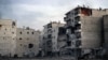 A fire is seen inside an apartment (R) of a damaged building due to heavy fighting between Free Syrian Army fighters and government forces in Aleppo, Syria, December 5, 2012.