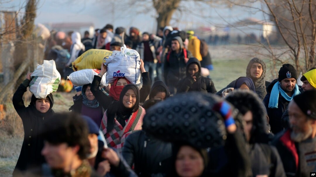 Image Description Migrants walk to reach Pazarakule border gate, Edirne, Turkey, at the Turkish-Greek border, March 1, 2020. 