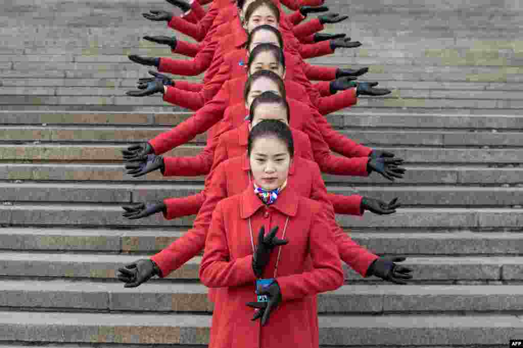 Hostesses pose for a picture during the opening session of the Chinese People's Political Consultative Conference (CPPCC) in the Great Hall of the People in Beijing. The CPPCC plays a largely symbolic role, with members meeting once a year to discuss social and economic policies.