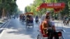 FILE - Chinese tourists ride rickshaws for sightseeing in Hanoi, Vietnam.