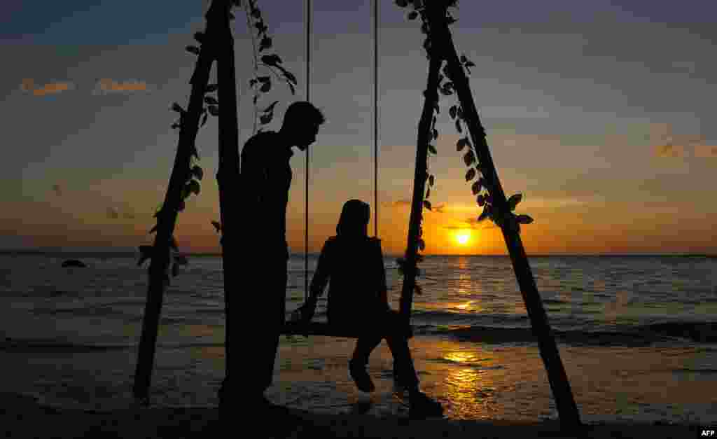 An Acehnese couple enjoy the sunset at Lhok Nga beach on Valentine's day in Aceh.