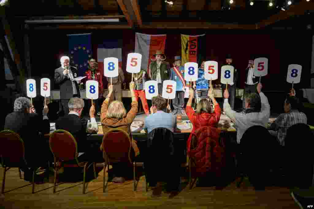 Competitors receive scores during a beard and moustache competition at the Ecomusee d&#39;Alsace in Ungersheim, France.
