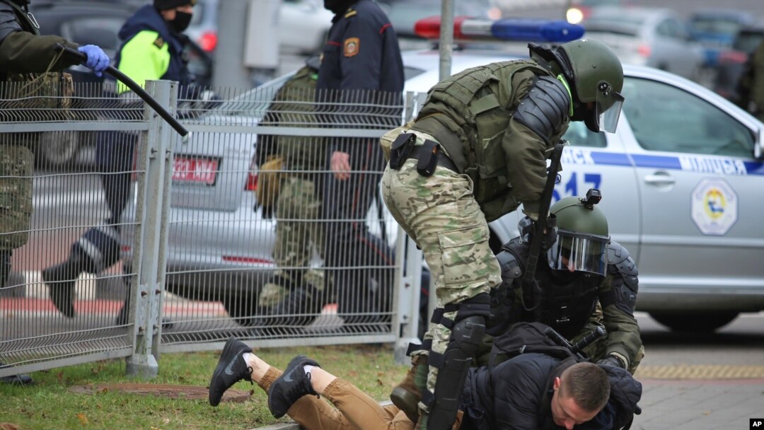 Police detain a man during an opposition rally to protest the official presidential election results in Minsk, Belarus, Nov. 1, 2020.