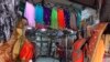 A salesman cleans a cloth shop in Mumbai, India, June 8, 2020. India is reopening its restaurants, shopping malls and religious places in most of its states after a more than 2-month-old lockdown.